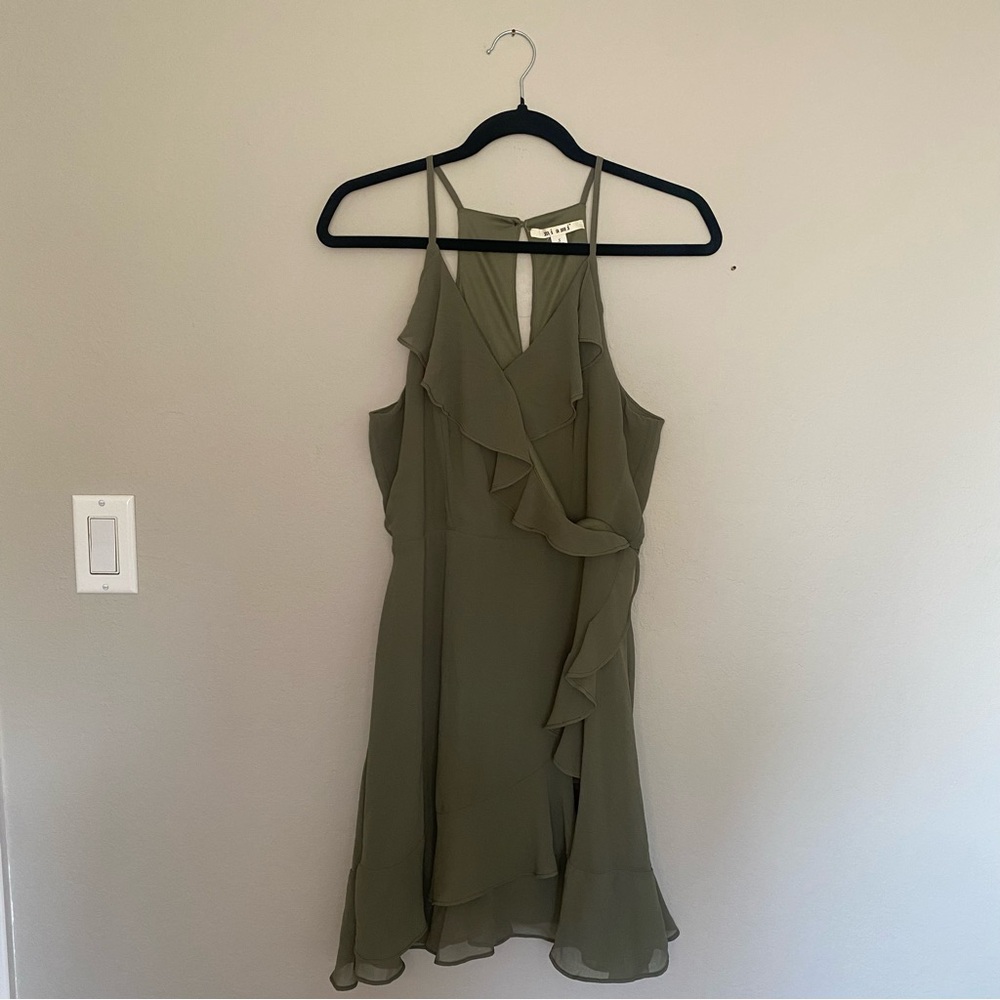 Sage green spaghetti strap mini dress with ruffles.